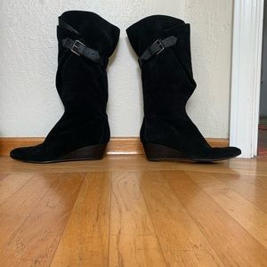 Black suede knee high boots with leather buckle.